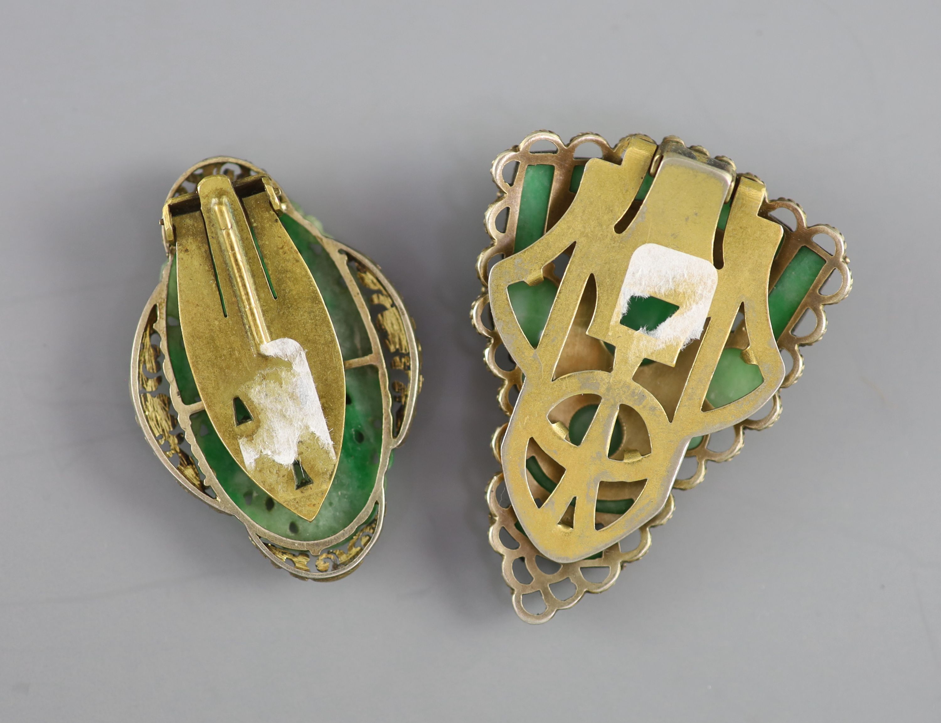 Two Chinese jadeite and gilt metal clips, first half 20th century and a yellow metal jadeite ‘fish’ ring, late 20th century, Clips 4.5 and 5cm